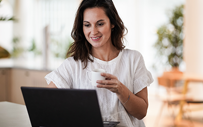 FAQMB - Laptop, coffee cup, and FOCL supplements on a table - Promoting clarity, focus, and calm.