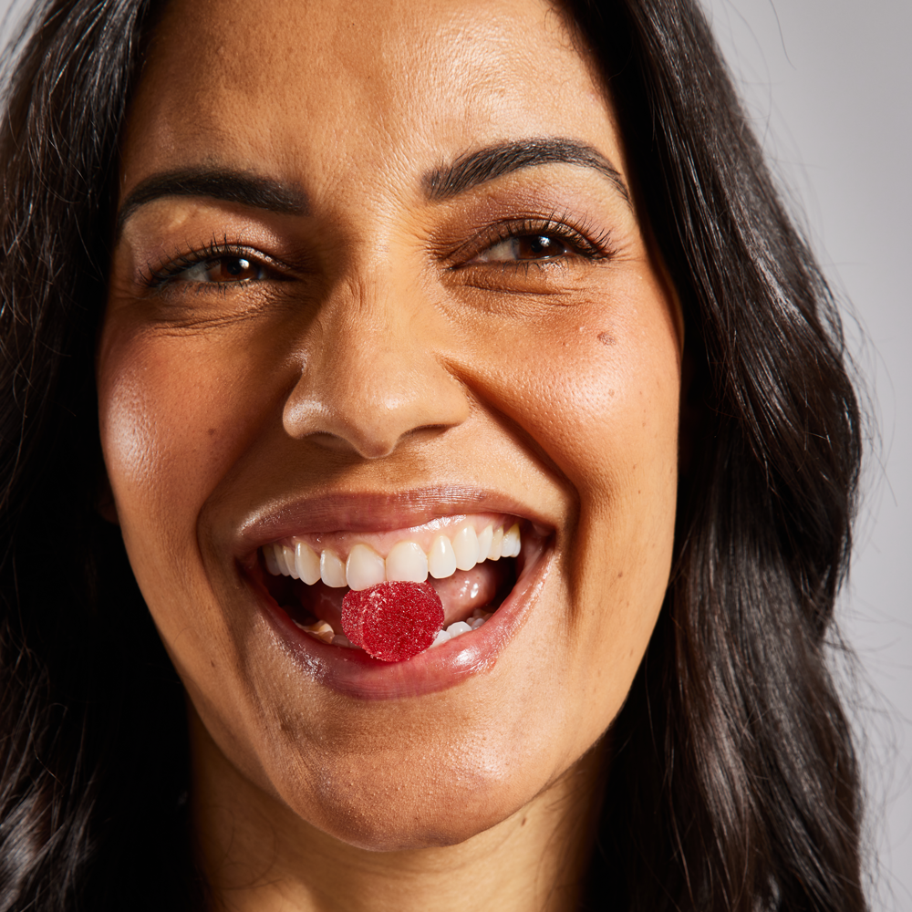 FOCL wellness supplement bottle held by a smiling woman - supports sleep, calm, and focus.