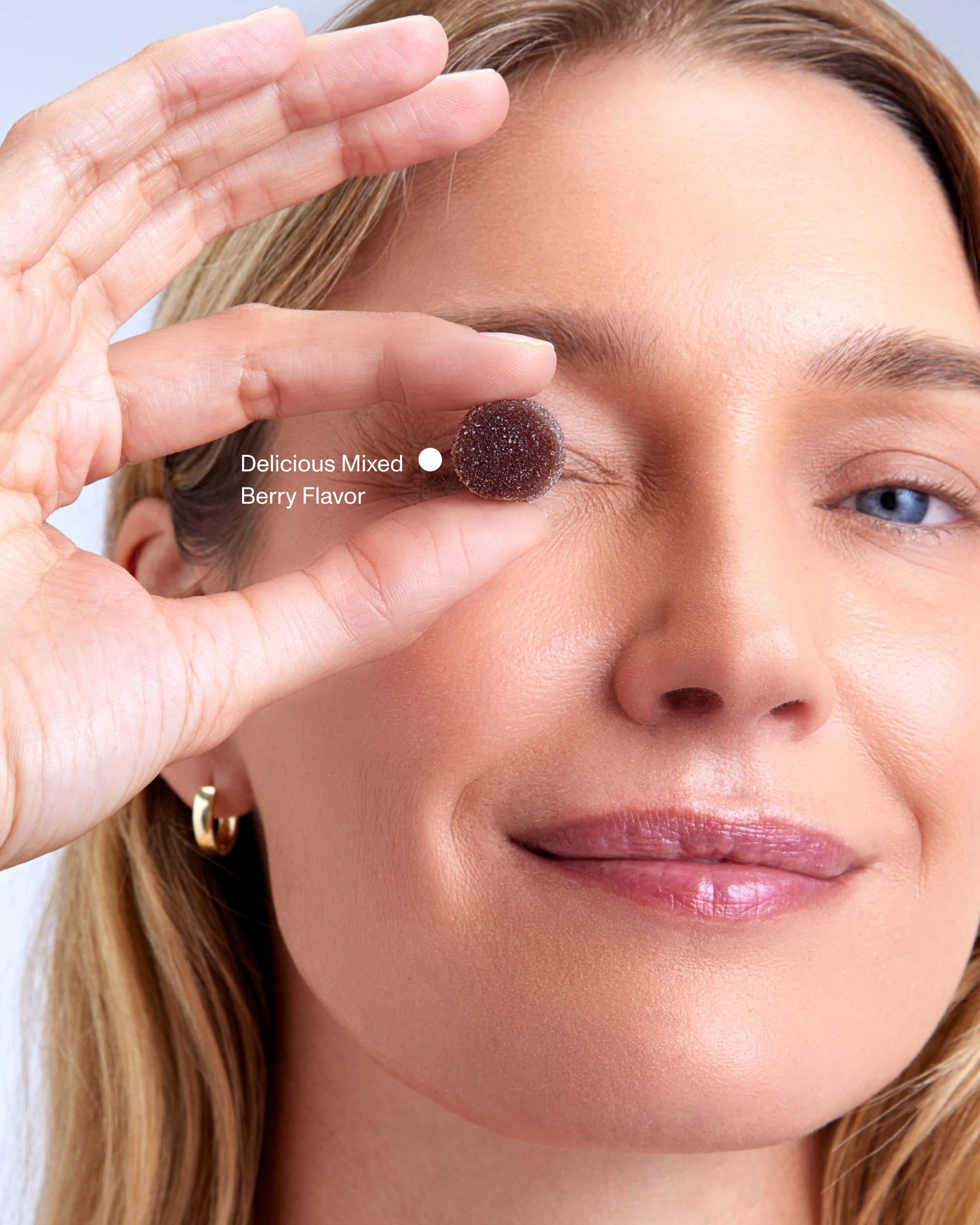 FOCL BetterBrain Gummies - A woman enjoying plant-based wellness supplement for improved focus and clarity.
