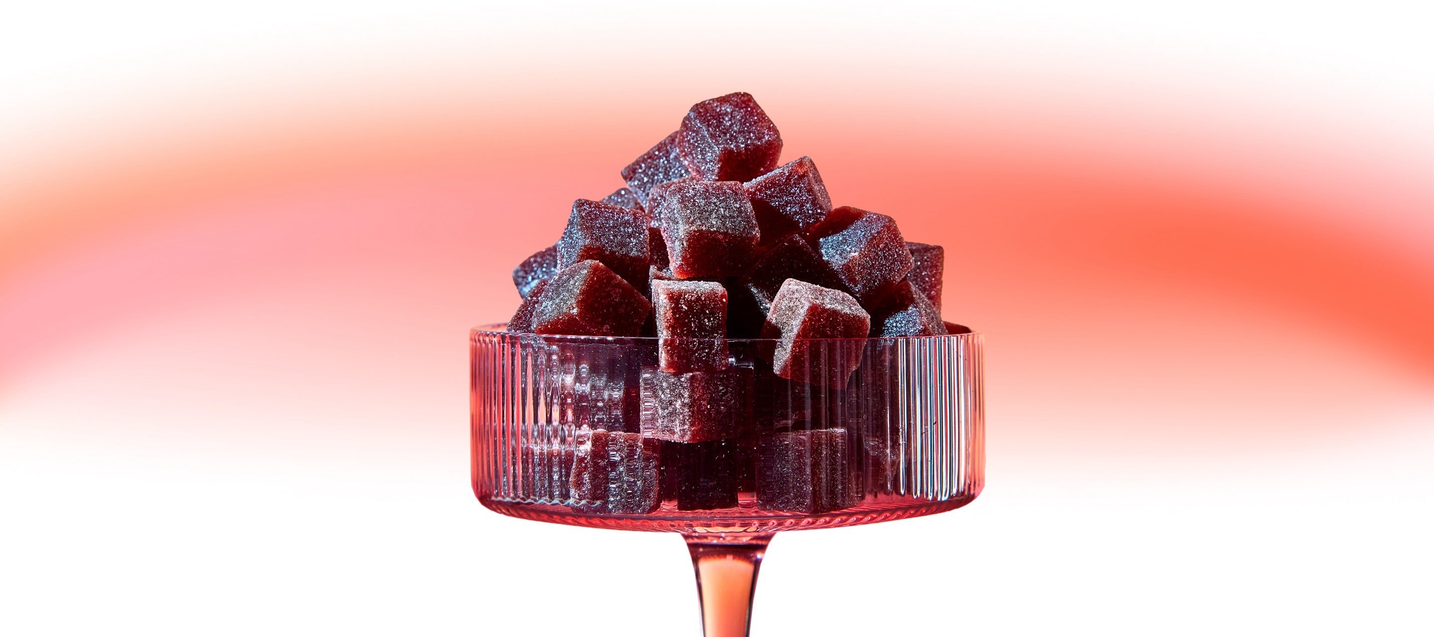 Kava gummies in a wine glass on a desktop - Promoting calm and focus with FOCL's plant-based supplements.