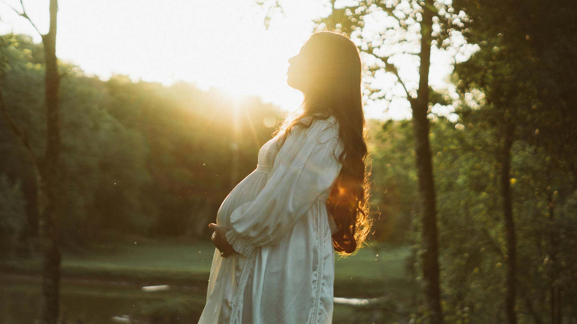 pregnant woman standing outside