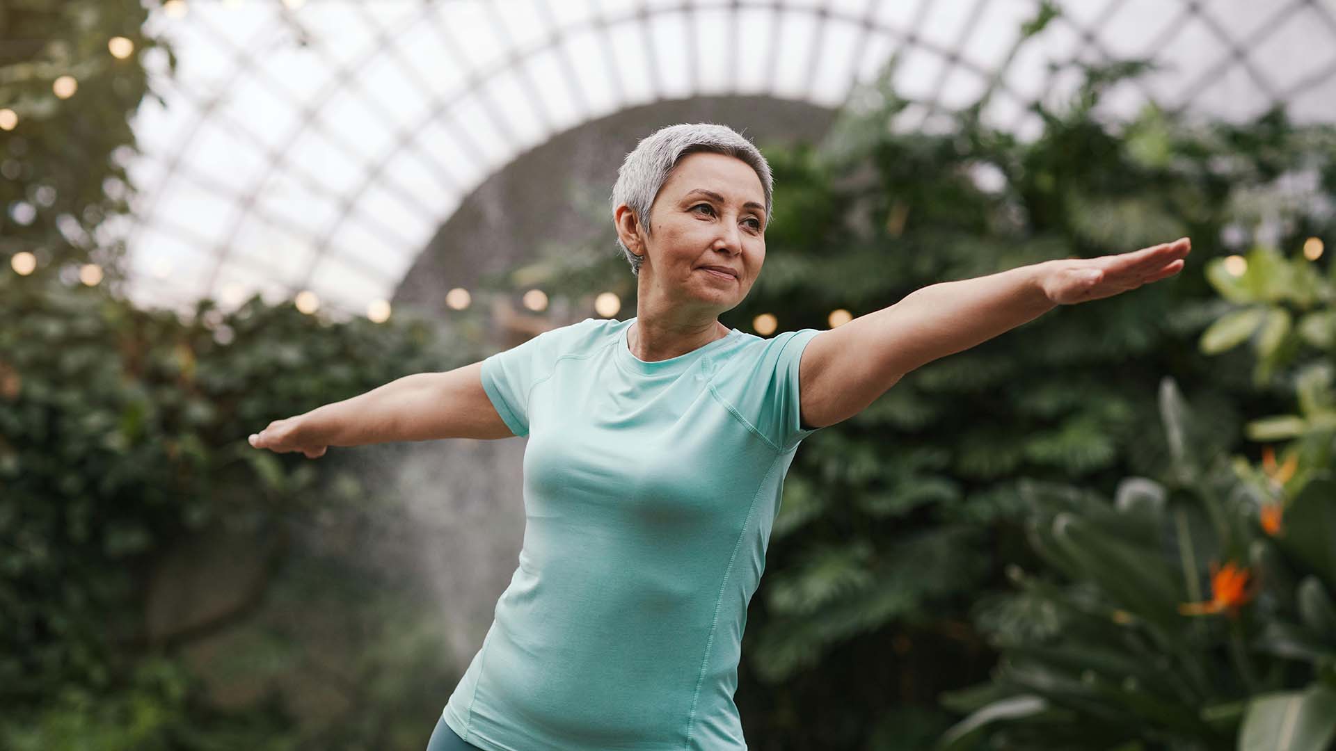 Senior woman doing yoga in a garden