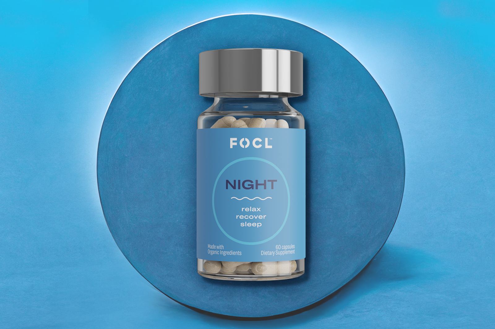 Jar of FOCL Night capsules on a blue background.