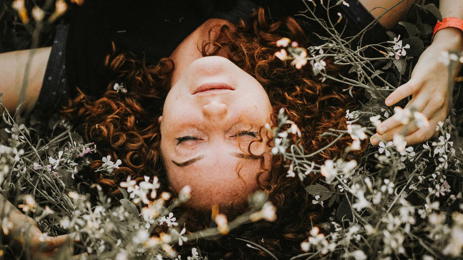 woman sleeping among flowers