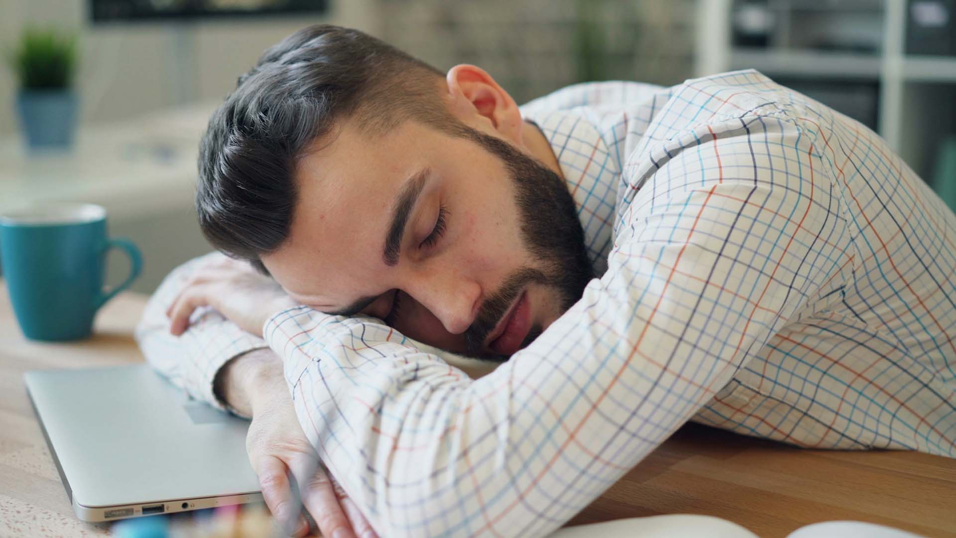 A man asleep at a desk