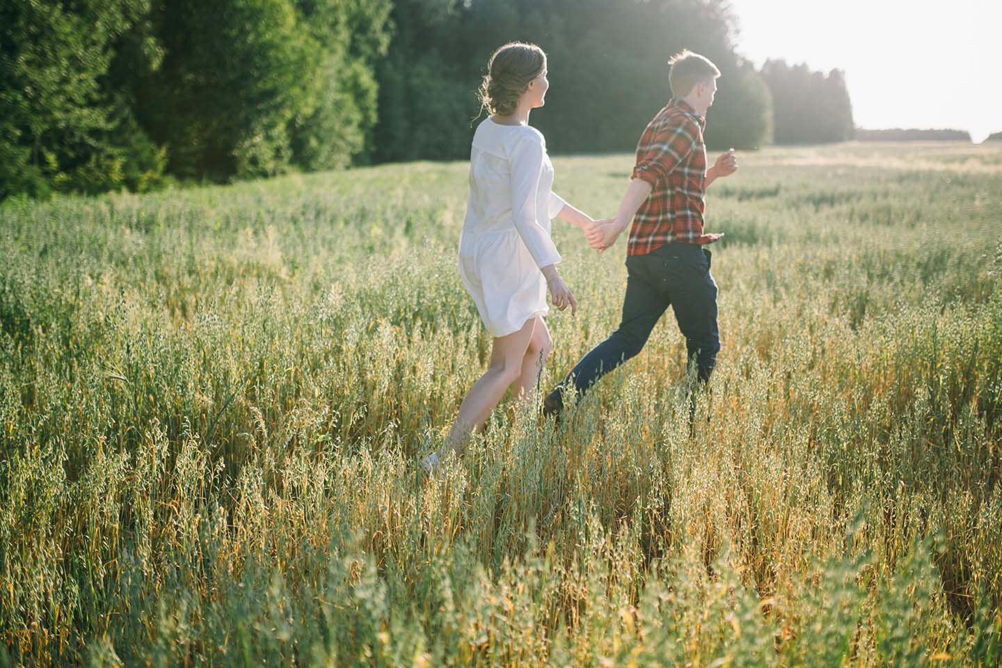 a couple walking on a grass field