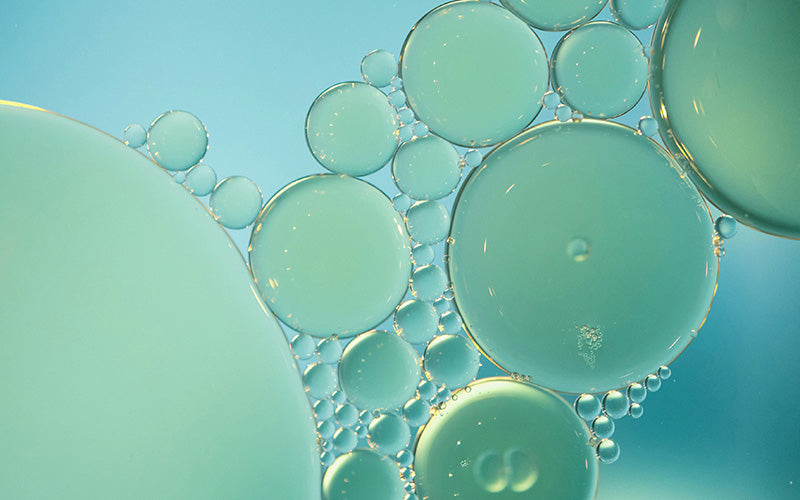 close-up of oil bubbles in blue green color