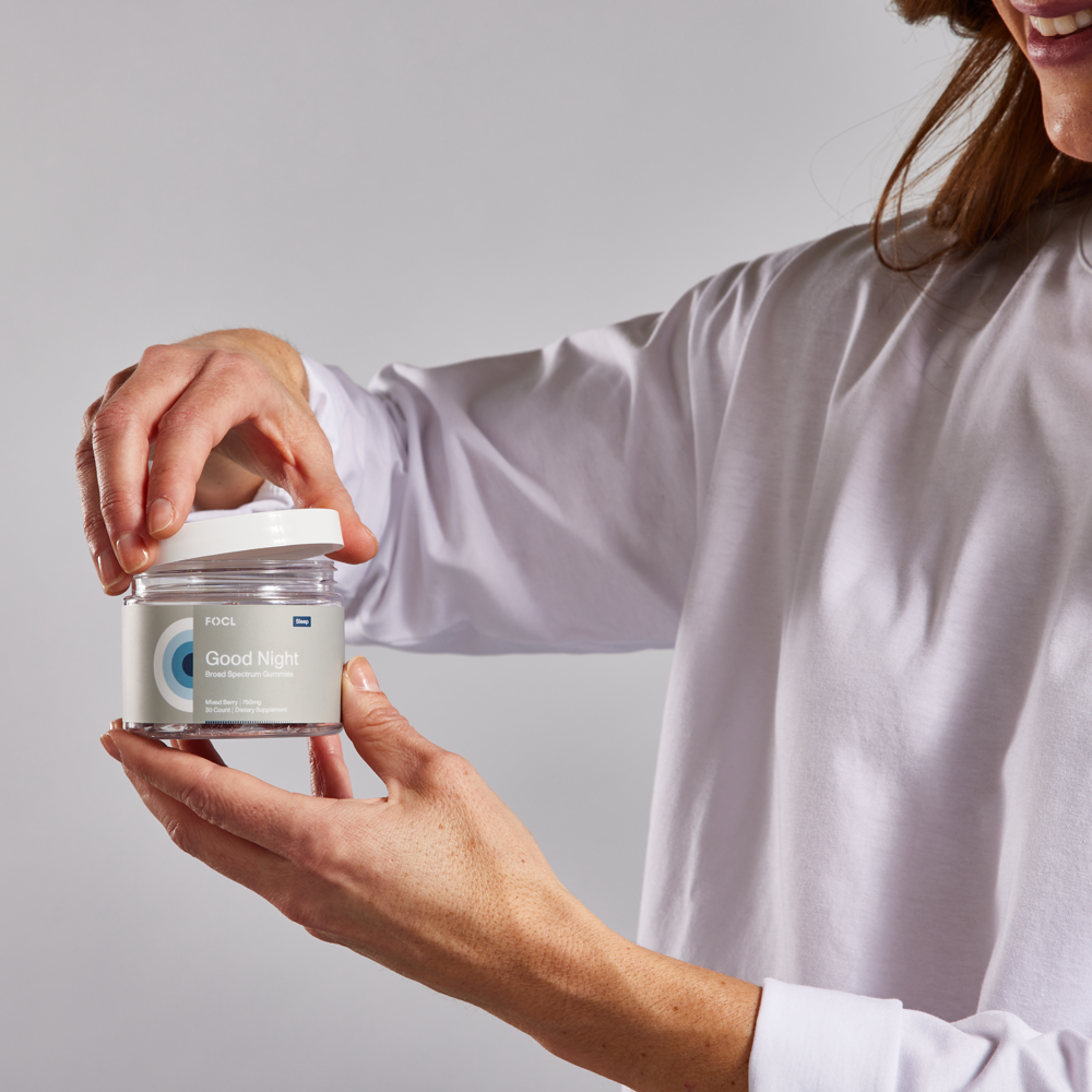 FOCL Goodnight supplement bottle on bedside table promoting restful sleep and calm.