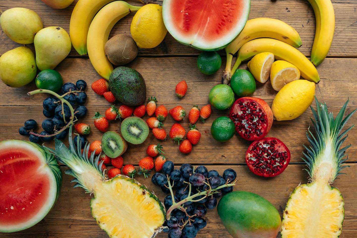 Assorted tropical fruits and berries on a wooden table