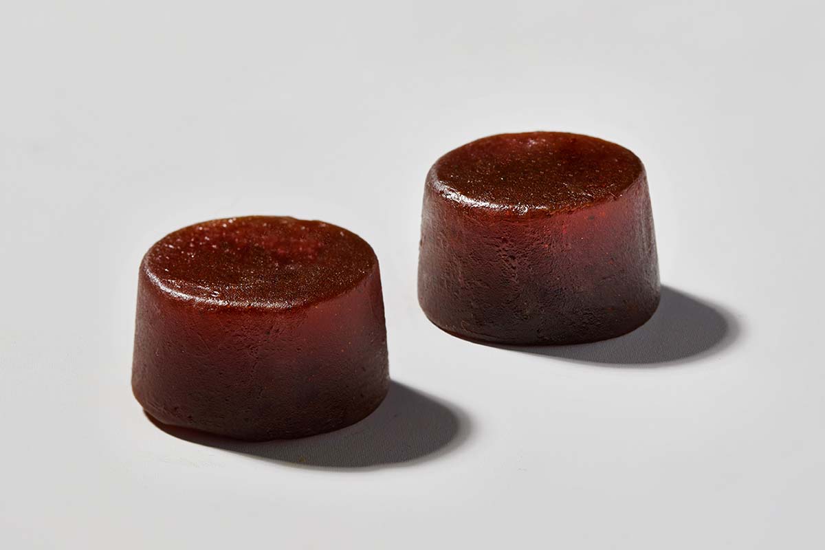 close up photography of two dark red gummies